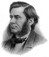 Photo portrait en noir et blanc de Thomas Henry Huxley, il porte une barbe