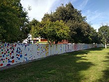 Walker Wall, a flood barrier constructed at Pomona College in Claremont, California in 1956, has since been repurposed into a free speech wall. Walker Wall, Pomona College.jpg