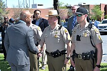 Moore greeting police officers in Hanover, Maryland, 2023 Work Zone Safety Press Conference (52829819543).jpg