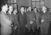 Rudolf Hess, Heinrich Himmler and Reinhard Heydrich listening to Konrad Meyer at a Generalplan Ost exhibition, 20 March 1941. Bundesarchiv Bild 183-B01718, Ausstellung "Planung und Aufbau im Osten".jpg