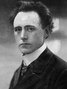 Black and white photograph of a man wearing a suit and tie