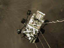 The rover photographed from the sky crane during descent NASA-MarsPerseveranceRover-LandingDrop-20210218.png
