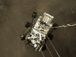 The rover photographed from the sky crane during descent