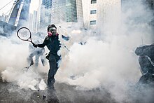 Tear gas used during the 2019-2020 Hong Kong protests. Use of tear gas on protestors is sometimes considered a form of torture. Protesters use tennis rackets to bat away tear gas. (50267655062).jpg