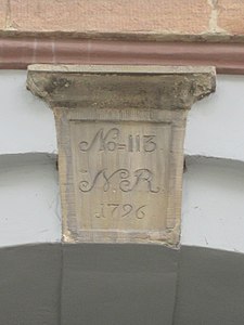 The keystone above the gate with the old and new cadastrel numbers No. 113 No. 79
