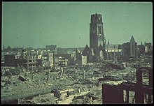 Rotterdam's city centre after the bombing in 1940. The heavily damaged (now restored) St. Lawrence church stands out as the only remaining building that is reminiscent of Rotterdam's medieval architecture. (Agfacolor) Het verwoeste Hang met de Steigersgracht en Sint-Laurenskerk 1940.jpg