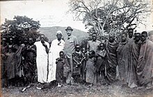 Later chief Meli as boy standing next to Dr.Hans Meyer visiting the Meli family before his Kilimanscharo ascent