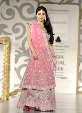 Indian actress Shriya Saran. In many cultures, pink is associated with femininity.