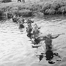 Infantrymen of the 9th Battalion, Royal Warwickshire Regiment, wading across a stream, Northern Ireland, 11 September 1942. The leading man is carrying a Boys anti-tank rifle. The British Army in the United Kingdom 1939-45 H23857.jpg