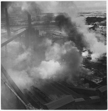 United Kingdom. Consett, England. Night and day, seven days and seven nights a week, whirling smoke cloud rise from... - NARA - 541767.tif