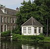 Speelhuis, gepleisterd rechthoekig gebouwtje onder met pannen gedekt tentdak. Op het terrein van het Huis "Middendorp" aan de Vliet