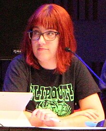 Cropped image of Watson on a convention panel