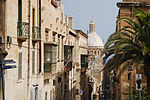 Coastal city with churches and a large dome.