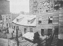 Rear pre-Civil War Era tenements constructed of wood in Mulberry Bend in the Five Points neighborhood around 1872, Board of Health. Five Points New York City C.1879.gif