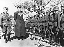 General Andrey Vlasov (centre), accompanied by a German general, inspects a detachment of the Russian Liberation Army. Genaral Andriej Wlasow podczas przegladu swoich jednostek (2-1984).jpg