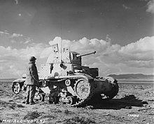 A US soldier with an abandoned Italian medium tank after the Battle of Kasserine Pass, 25 February 1943 SC 170094 - Light medium Italian tank. Tunisia. 25 February, 1943. (52233751864).jpg