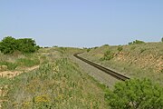After a long climb, the BNSF railroad crosses the top of the Caprock Escarpment and extends onto the level plains of the Llano Estacado at Southland.