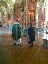 Preparing for the celebration of mass in Strangnas Cathedral, Church of Sweden Strangnas Cathedral interior.jpg