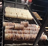 Trdelník being baked in a stall in Wenceslas Square, Prague