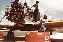 Mechanics working on a Texan trainer, c. 1943 WAVES mechanics work on a North American SNJ at Naval Auxiliary Air Station Whiting Field, circa in 1944 (80-G-K-15003).jpg