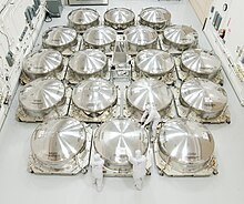 The 18 main mirror segments for JWST in special shipping cans, 2012 Yes, the James Webb Space Telescope Mirrors 'Can' (7986235455).jpg