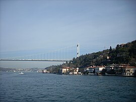 A view of the shores of Anadoluhisarı with Fatih Sultan Mehmet Bridge in the background