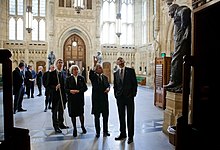 The Lord Great Chamberlain, the 7th Marquess of Cholmondeley (left), holding his white staff of office; the Lord Speaker, Baroness Hayman; and the Speaker of the House of Commons, John Bercow, showing US President Barack Obama around Members' Lobby during a tour of the Palace in May 2011. Barack Obama in the Members' Lobby of the Palace of Westminster, 2011.jpg