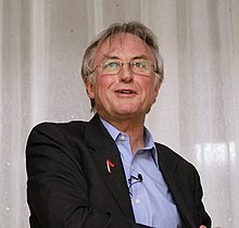 Wearing a scarlet 'A' lapel pin, at the 34th annual conference of American Atheists (2008) Dawkins aaconf.jpg
