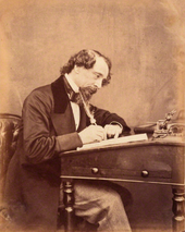English writer Charles Dickens at his desk in 1858 Dickens by Watkins 1858.png