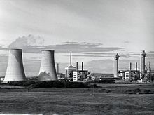 The site in 1956. In foreground Calder Hall cooling towers and two Magnox reactors. Background L to R: First Generation reprocessing plant, Windscale pile chimneys. HD.15.003 (11824034284).jpg