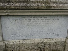 Latin grave inscription in Ireland, 1877; it uses distinctive letters U and J in words like APUD and EJUSDEM, and the digraph OE in MOERENTES. Latin inscription, Ireland.jpg