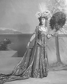 woman in costume with large fan