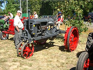 A Farmall tractor with road bands fitted to facilitate driving on paved roads