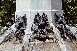 The pedestal of the fountain with statues of demons, lizards, fishes and snakes