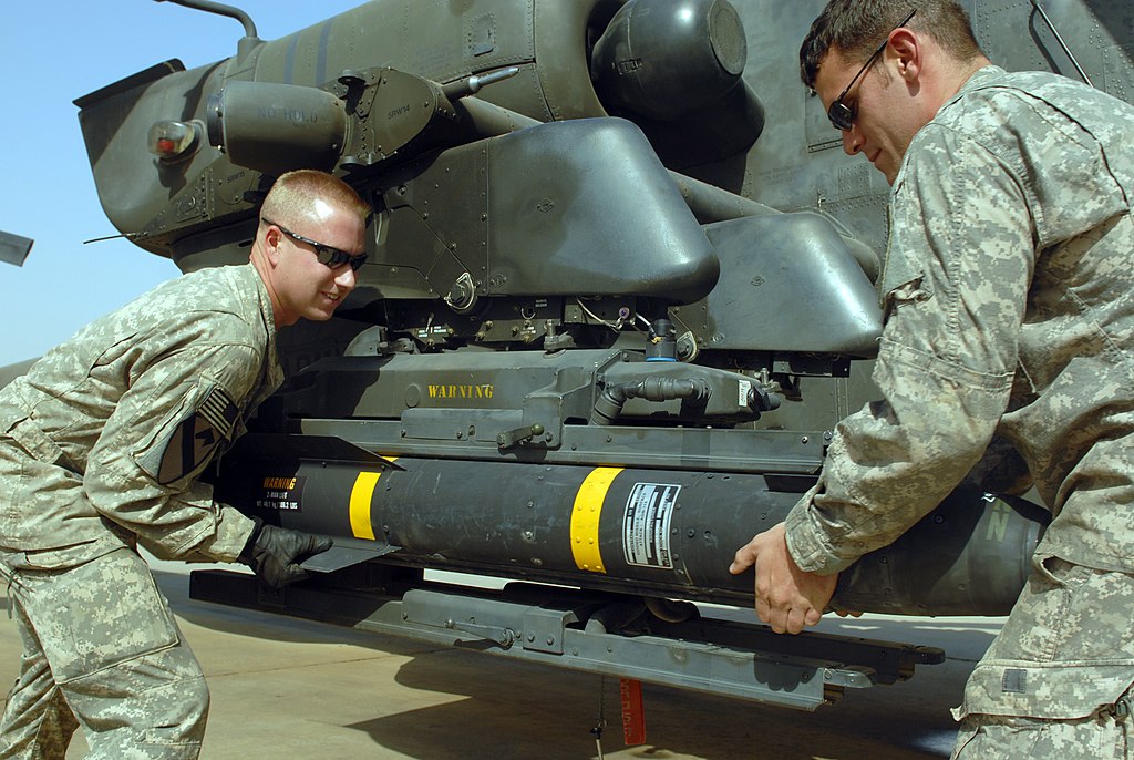 Russian Helicopter ATGMs 1024px-US_Army_52453_CAMP_TAJI,_Iraq_-_Spc._Sean_McConnell_(left),_of_Columbus,_Ohio,_and_Spc._Scott_Shaver,_of_Austin,_Texas,_load_a_Hellfire_missile_onto_the_mounting_bracket_on_an_AH-64D_Apache_helicopter,_here,_Oct._1