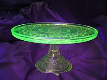 Uranium glass glowing under UV light U glass with black light.jpg