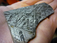 Widmanstatten pattern showing the two forms of nickel-iron, kamacite and taenite, in an octahedrite meteorite Widmanstatten hand.jpg