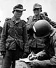 Yang Kyongjong (left) in Wehrmacht attire following capture by American paratroopers in June 1944 after D-Day