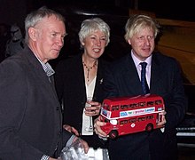 Johnson pledged to replace the city's articulated buses with New Routemaster buses if elected mayor Boris Johnson -holding a red model bus -2007.jpg