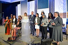 Melania Trump with 2017 International Women of Courage Awardees First Lady Melania Trump and Under Secretary Shannon Pose for a Photo With the 2017 International Women of Courage Awardees (33338548780).jpg