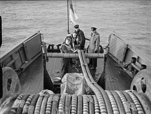 The towed, electric cables of Double-L, magnetic-minesweeping gear being deployed behind a Royal Navy minesweeper L L sweeping gear.jpg