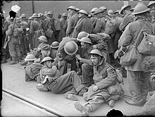 Exhausted British troops rest on the quayside at Dover, Kent, England, 31 May 1940. The British Army in the UK- Evacuation From Dunkirk, May-June 1940 H1643.jpg