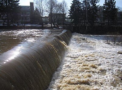 A weir creating a small cascade on a river in Finland Tikkurilankoski in April.jpg