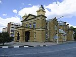 Sandstone building under hipped corrugated iron roof with bell-tower and louvred ventilators. Front façade with two decorative towers, sandstone portico and pediment. Sliding sash windows and timber doors with fanlights. The cornerstone of the building was laid on 14 March 1906 by the Mayor of Kroonstad, T W Hoseason. Building operations were started by B W Eastwood and Morris & Lightbody and completed by Rowe & Marshall. Architectural style: Neo-Classical. Type of site: Town Hall Current use: Town Hall. The sandstone building with its Neo-Classical features was designed by J H & A E Till. It was officially opened on 7 June 1907 by Sir Hamilton Goold-Adams, Lieutenant-Governor of the Orange River Colony. It forms part of an important architectural group a