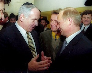 Russian president Vladimir Putin with former I...