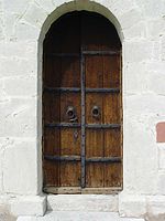 Saying "there may be a person behind that door" merely expresses ignorance about the one, determined reality. Gotland-Froejel-Kirche 03.jpg