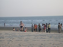 Three Ukrainian men, wearing trunks and briefs, attract attention for immodesty relative to the local norm in Cox's Bazar, Bangladesh. Immodest ukrainians bangladesh.jpg