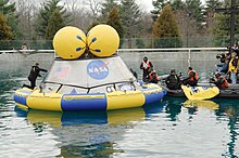 NASA and DoD personnel familiarize themselves with a Navy-built, 18,000-pound (8,200 kg) Orion mock-up in a test pool at the Naval Surface Warfare Center's Carderock Division in Potomac, Md. Orion water test.jpg