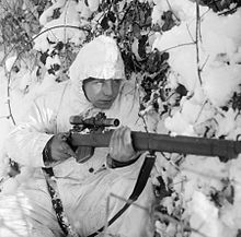 A 6th Airborne Division sniper on patrol in the Ardennes, 14 January 1945. A 6th Airborne Division sniper on patrol in the Ardennes, wearing a snow camouflage suit, 14 January 1945. B13676.jpg