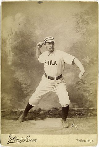 A sepia-toned baseball card image of a man wearing an old-style white baseball uniform and striped pillbox cap